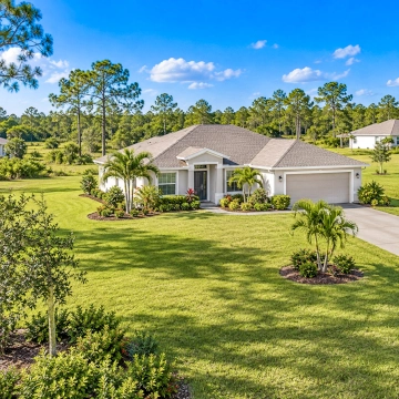 Spacious single-family home with a large yard in Lehigh Acres, representing larger lots and more space for buyers